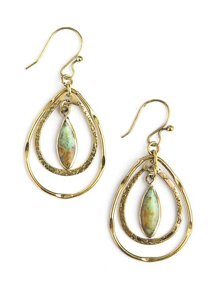 Gold hoop earrings with green gemstones on a white background