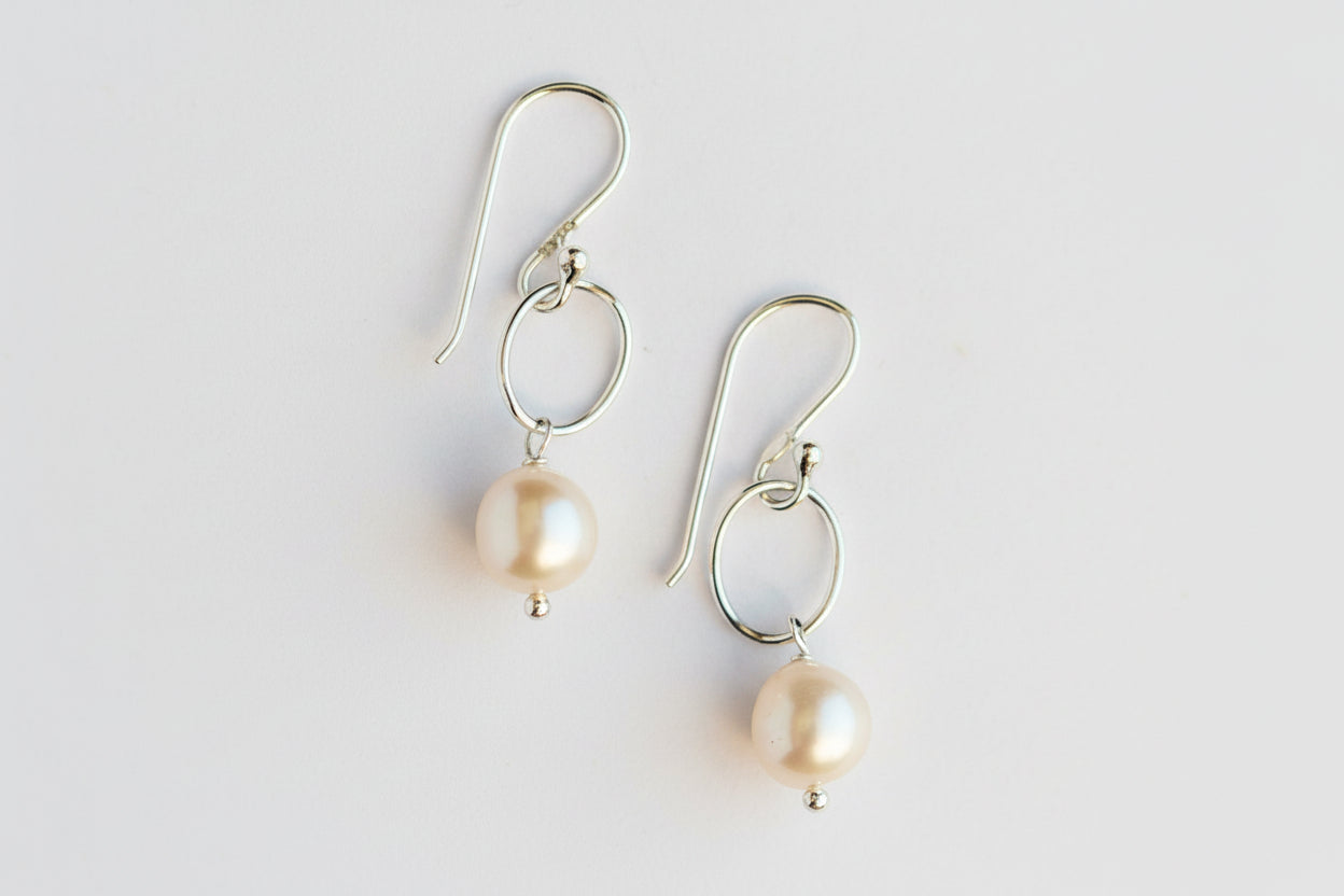 Pair of pearl earrings on a white background